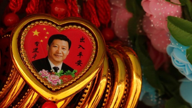 Souvenir necklaces with a portrait of Chinese President Xi Jinping are displayed for sale at a stall in Tiananmen Square in Beijing, China, February 26, 2018.  REUTERS/Thomas Peter