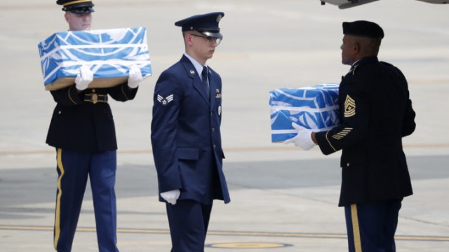 Soldiers carry caskets containing remains of U.S. soldiers who were killed in the Korean War during a ceremony at Osan Air Base in Pyeongtaek, South Korea, Friday, July 27, 2018. North Korea on Friday returned the remains of what are believed to be U.S. servicemen killed during the Korean War, the White House said, with a U.S military plane making a rare trip into North Korea to retrieve 55 cases of remains. (Kim Hong-Ji/Pool Photo via AP)